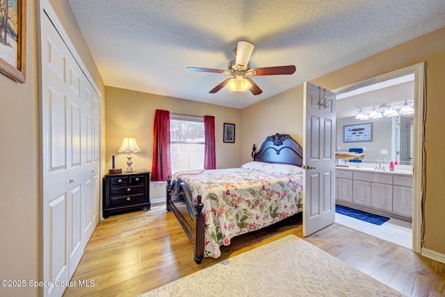 bedroom featuring light hardwood / wood-style floors, a closet, and a textured ceiling