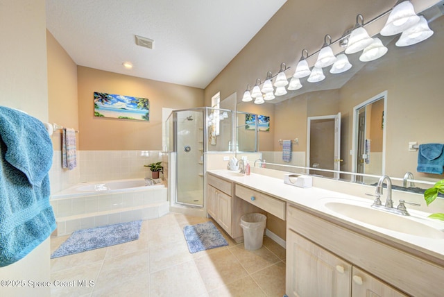 bathroom featuring plus walk in shower, tile patterned floors, and vanity