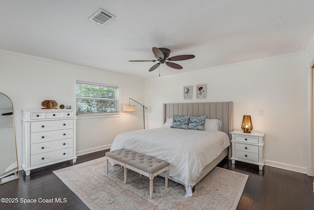 bedroom with crown molding, dark wood-type flooring, and ceiling fan