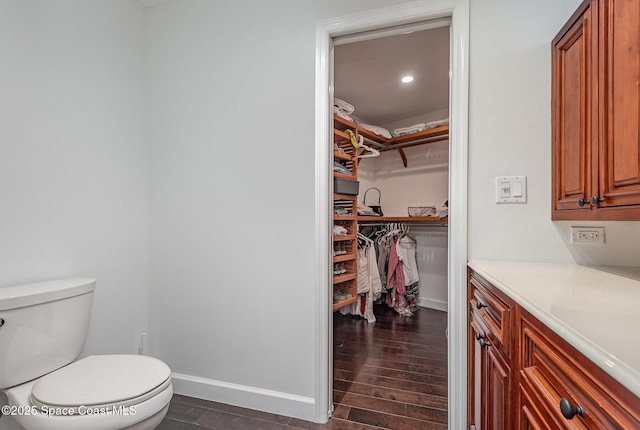 bathroom with hardwood / wood-style flooring and toilet