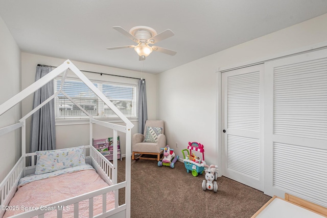 carpeted bedroom featuring ceiling fan and a closet