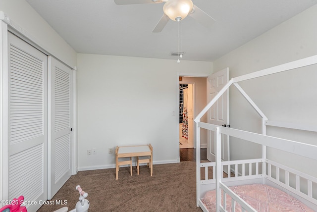 bedroom with a closet, ceiling fan, and dark colored carpet