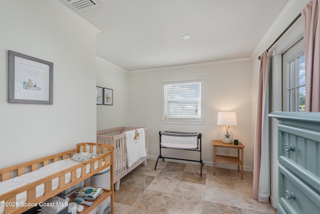 bedroom with ornamental molding and a textured ceiling