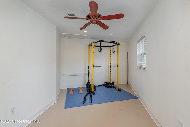 workout room featuring a textured ceiling