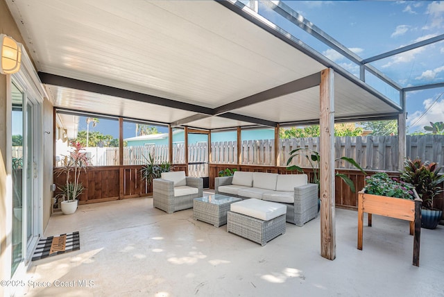 sunroom / solarium featuring a water view and plenty of natural light