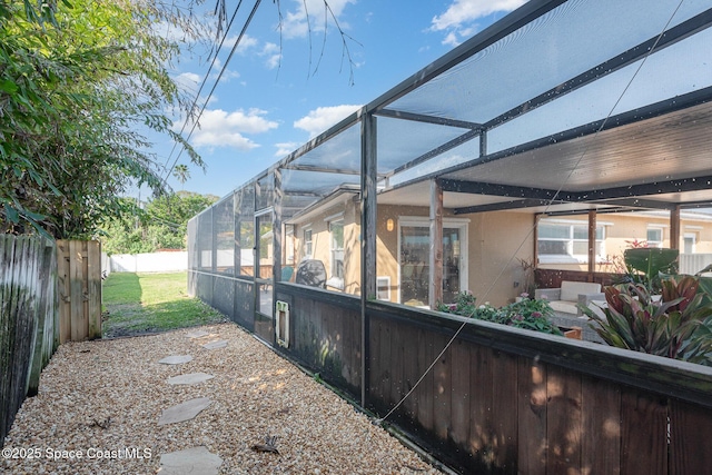 view of side of property with glass enclosure