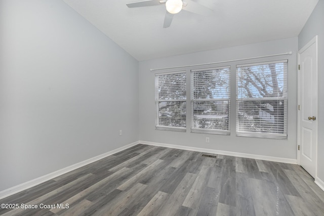 spare room with wood-type flooring, vaulted ceiling, and ceiling fan