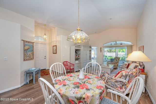 dining room with hardwood / wood-style flooring and lofted ceiling