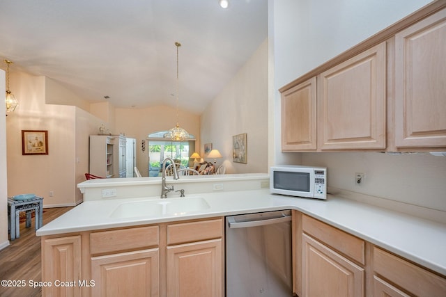 kitchen featuring sink, stainless steel dishwasher, kitchen peninsula, and light brown cabinets