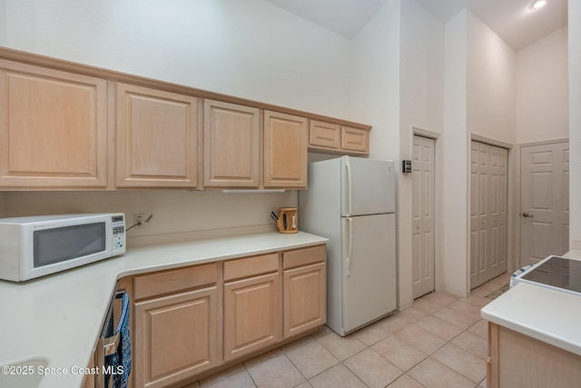 kitchen featuring high vaulted ceiling, light brown cabinets, white appliances, and light tile patterned floors