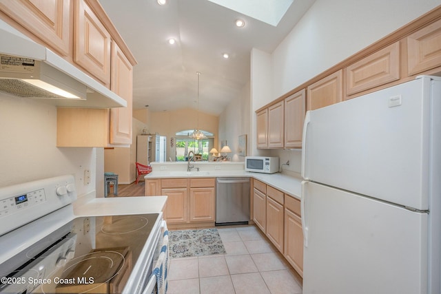 kitchen featuring pendant lighting, sink, white appliances, light brown cabinetry, and kitchen peninsula