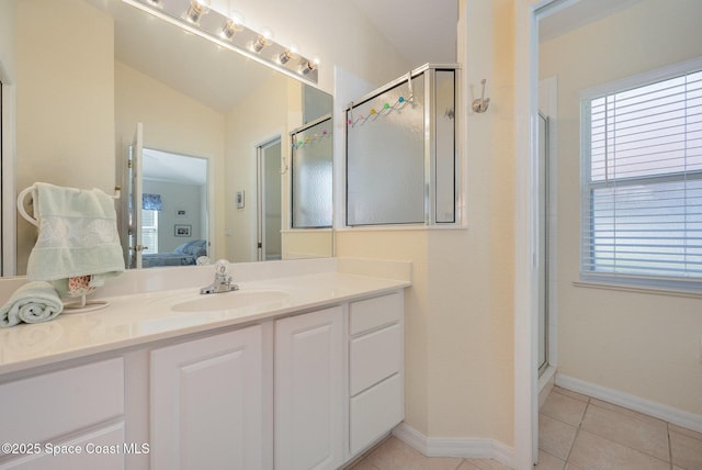 bathroom featuring tile patterned flooring, vanity, and a shower with door