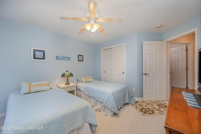 bedroom with ceiling fan, carpet floors, and a closet