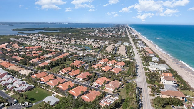 birds eye view of property featuring a view of the beach and a water view