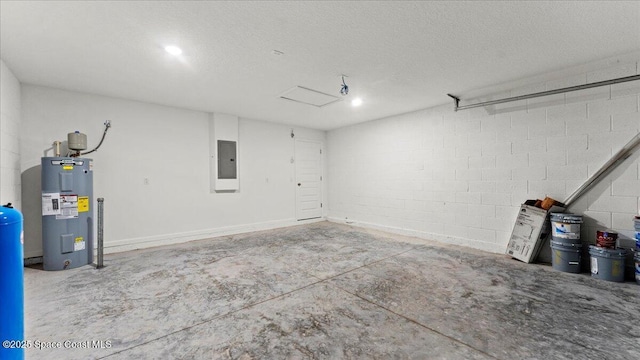 garage featuring concrete block wall, electric panel, and electric water heater