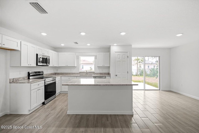1305 Harper Blvd SW, Palm Bay, FL 32908 - kitchen featuring stainless steel appliances, a sink, plenty of natural light, a center island, and recessed lighting
