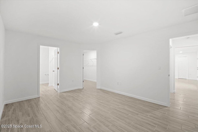 1305 Harper Blvd SW, Palm Bay, FL 32908 - spare room featuring light wood-style flooring, baseboards, and recessed lighting