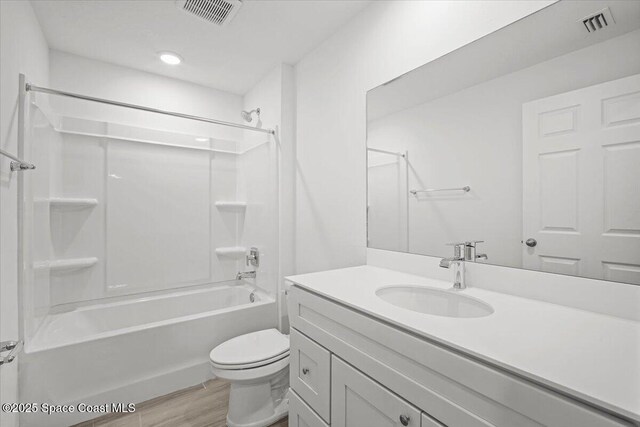 1305 Harper Blvd SW, Palm Bay, FL 32908 - full bath with vanity, toilet, washtub / shower combination, wood finished floors, and recessed lighting