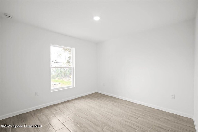 1305 Harper Blvd SW, Palm Bay, FL 32908 - empty room featuring a smoke detector, light wood-style flooring, baseboards, and recessed lighting