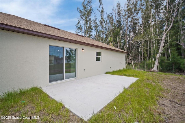 1305 Harper Blvd SW, Palm Bay, FL 32908 - back of property with a patio area, stucco siding, and a yard