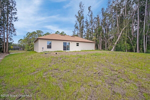 1305 Harper Blvd SW, Palm Bay, FL 32908 - rear view of property with stucco siding and a lawn