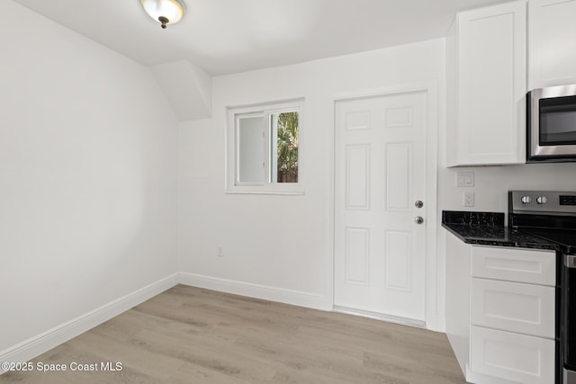 kitchen with appliances with stainless steel finishes, light wood-style flooring, and white cabinetry