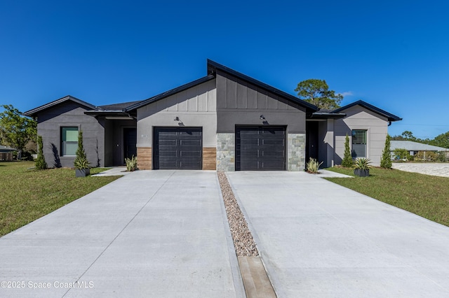 view of front of home with driveway, stone siding, an attached garage, board and batten siding, and a front yard