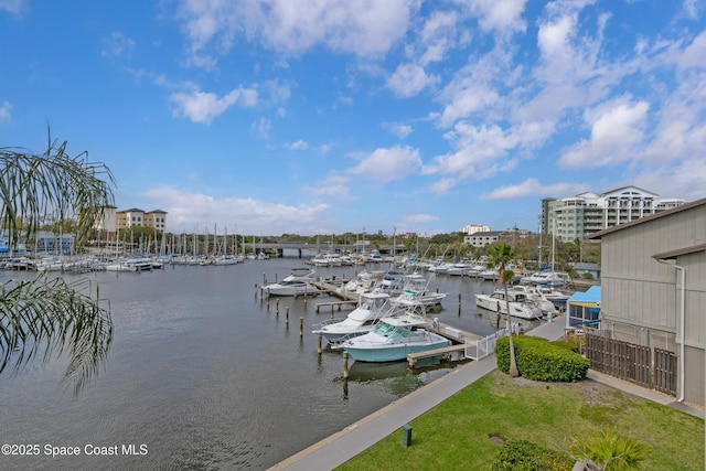 dock area featuring a water view and a lawn