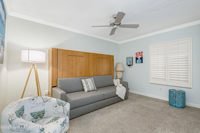 living area featuring a textured ceiling, ornamental molding, carpet flooring, and baseboards