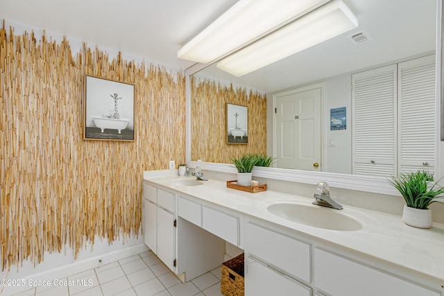 full bathroom with double vanity, visible vents, a sink, and tile patterned floors