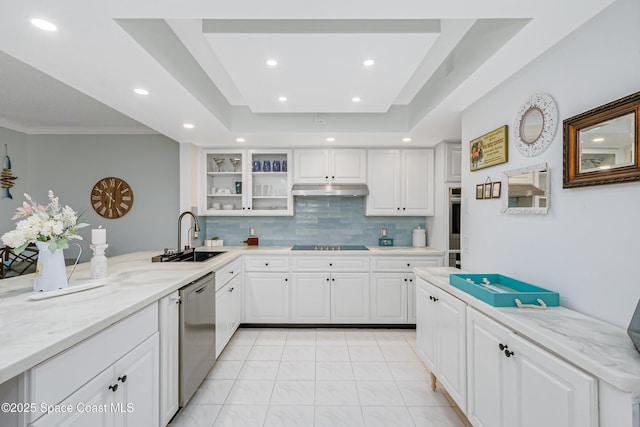 kitchen featuring black electric cooktop, under cabinet range hood, a sink, stainless steel dishwasher, and a raised ceiling