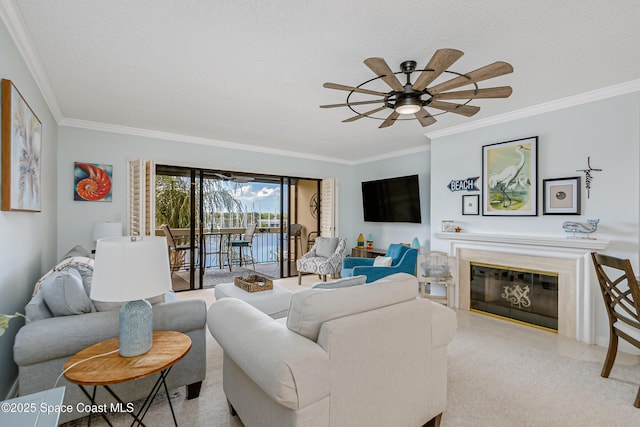 living area featuring a glass covered fireplace, carpet flooring, crown molding, and a textured ceiling