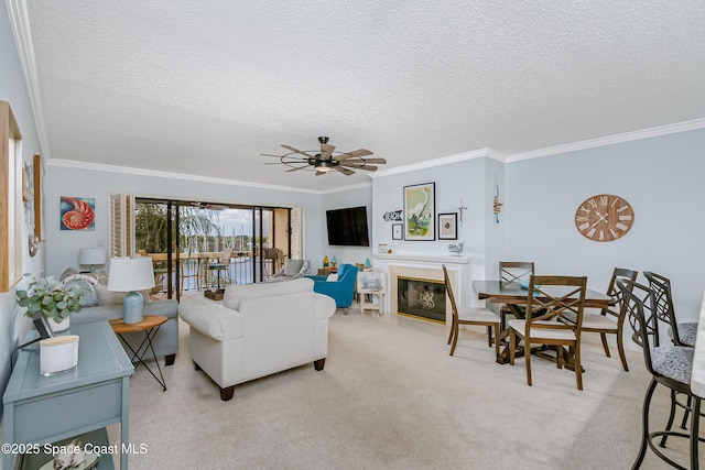 living room with carpet floors, a fireplace with flush hearth, and ornamental molding