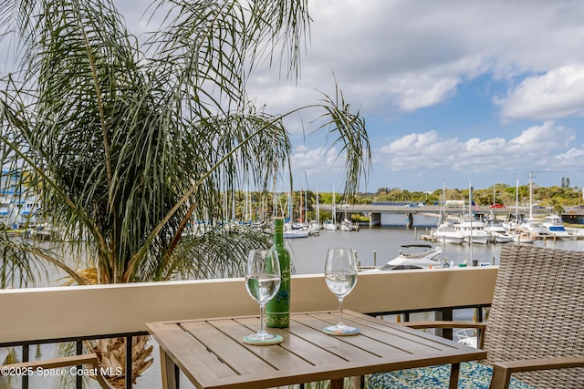 balcony featuring a water view and a dock