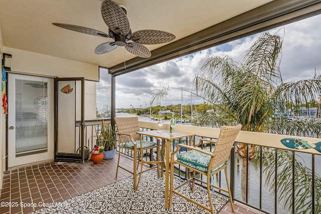 view of patio / terrace with a ceiling fan and a balcony