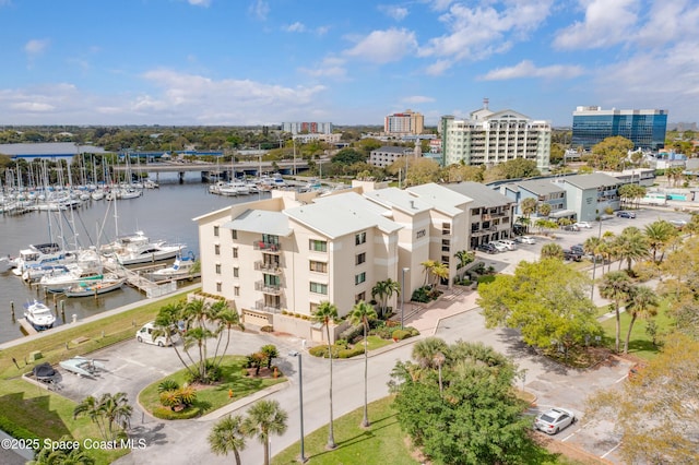 birds eye view of property featuring a water view and a city view