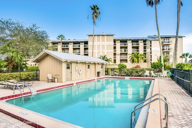 pool featuring a patio area and fence