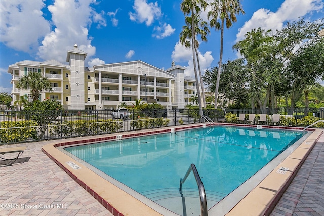 view of swimming pool featuring fence