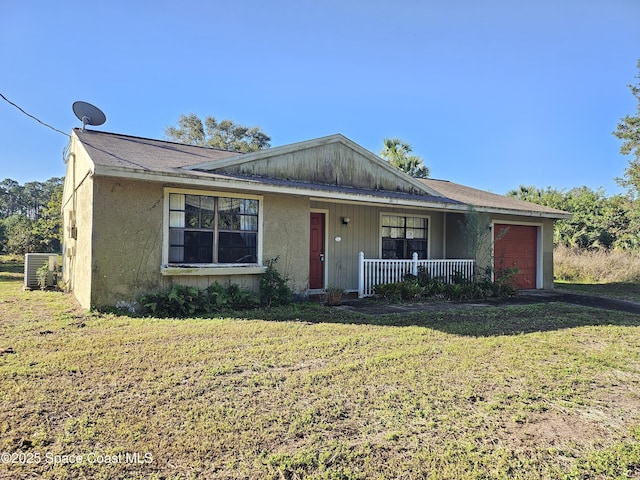 single story home featuring a garage, covered porch, a front yard, and central air condition unit