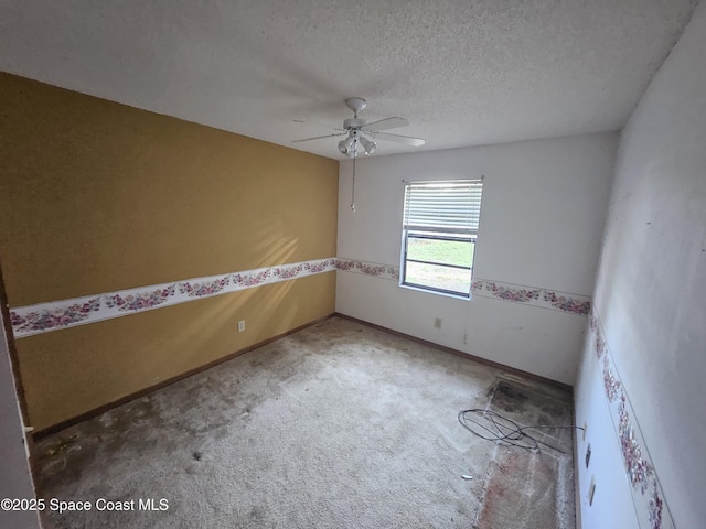 carpeted empty room featuring ceiling fan and a textured ceiling