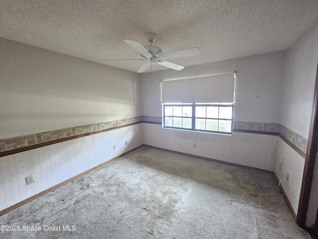 unfurnished room with carpet flooring and a textured ceiling