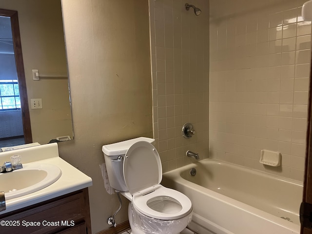 full bathroom featuring vanity, toilet, and tiled shower / bath