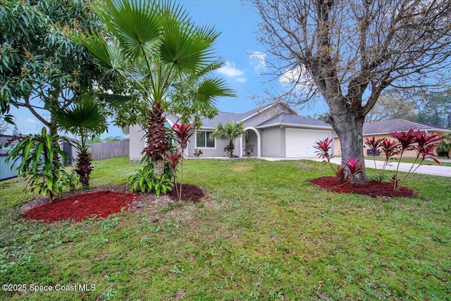 view of front of property with a garage and a front lawn