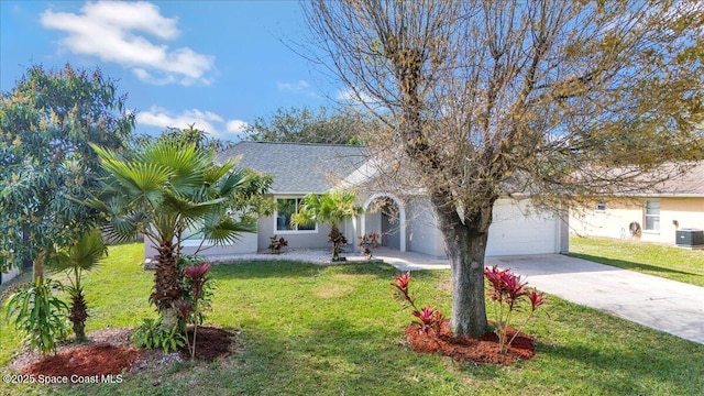 view of front of home with cooling unit, a garage, and a front lawn