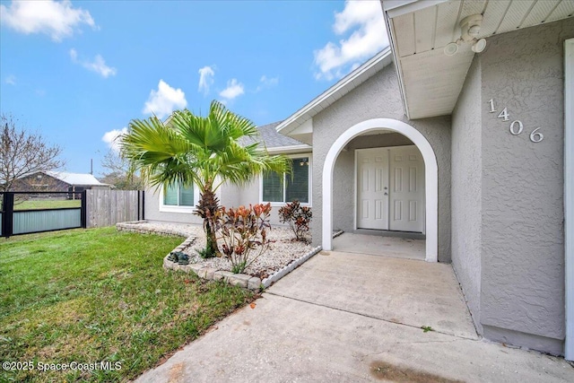 view of exterior entry with a lawn