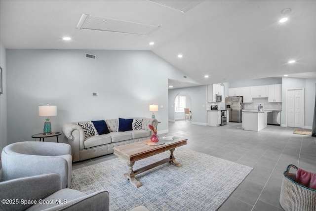 tiled living room with vaulted ceiling