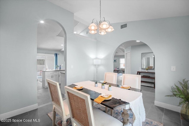 tiled dining area with an inviting chandelier