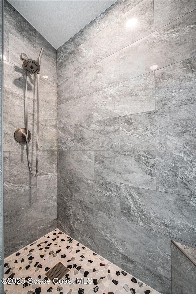 bathroom with a tile shower