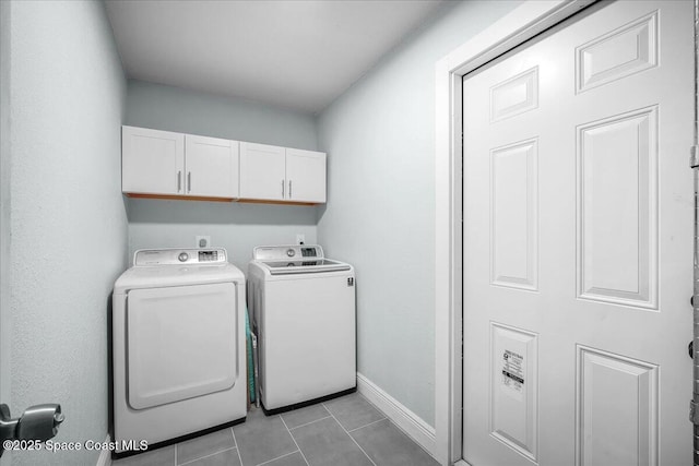 laundry area with cabinets, light tile patterned floors, and independent washer and dryer