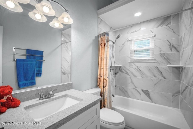 full bathroom with vanity, shower / tub combo, and toilet